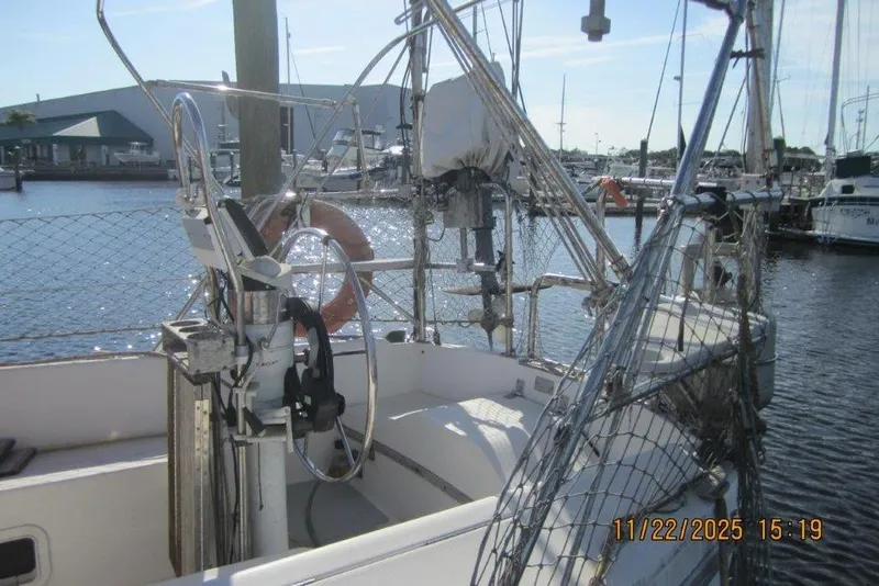 Slide: The Image of 1986 Catalina 30 MkII sailboat cockpit with marina background. - 18