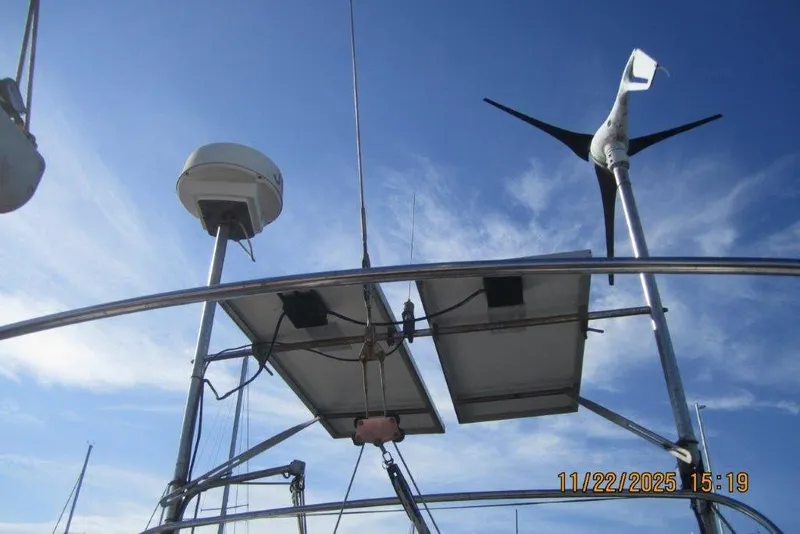 Slide: The Image of Catalina 30 MkII sailboat with solar panels and wind turbine, clear sky background. - 19