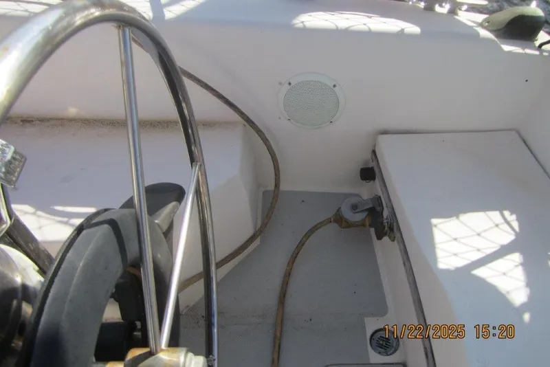 Slide: The Image of Steering wheel and cockpit of 1986 Catalina 30 MkII sailboat, with visible speaker and rope. - 23