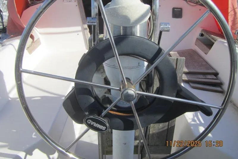Slide: The Image of Steering wheel of a 1986 Catalina 30 MkII sailboat, featuring a Simrad autopilot. - 24