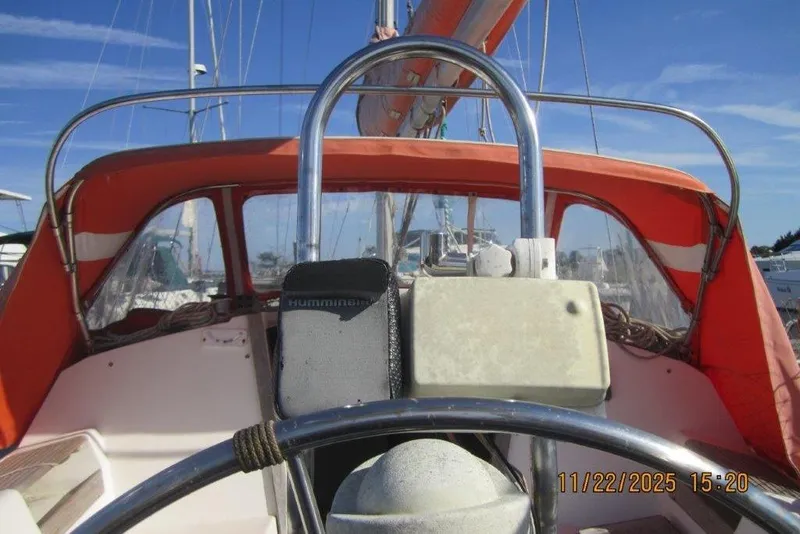 Slide: The Image of Cockpit view of 1986 Catalina 30 MkII sailboat with orange canopy and steering wheel. - 25