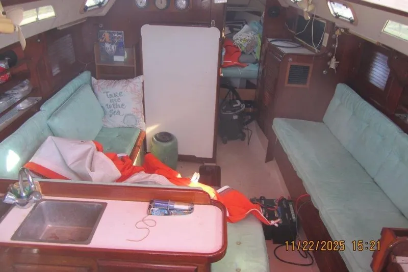 Slide: The Image of Interior of 1986 Catalina 30 MkII sailboat with cozy seating and nautical decor. - 28
