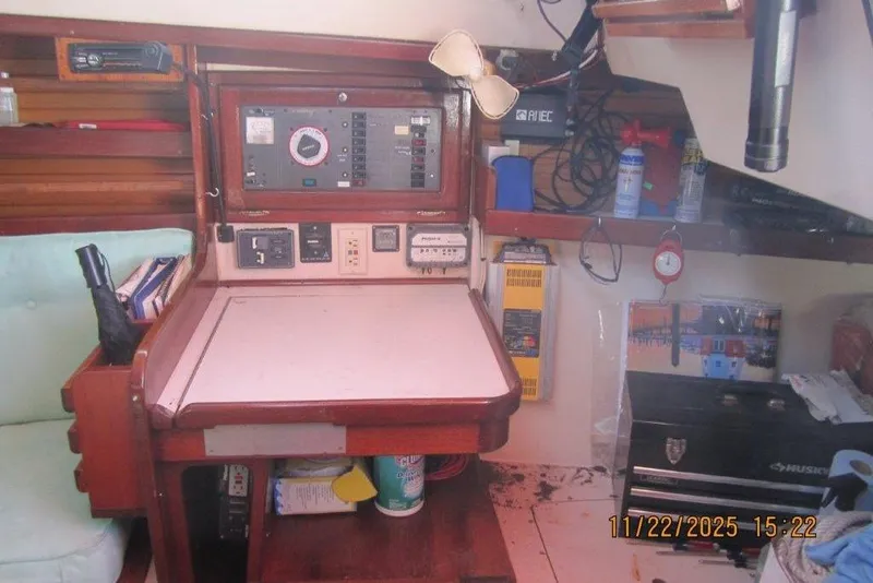 Slide: The Image of Navigation station inside a 1986 Catalina 30 MkII sailboat, featuring control panels and storage. - 33