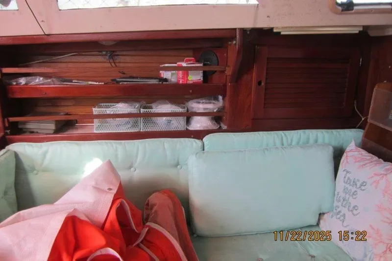 Slide: The Image of Interior of 1986 Catalina 30 MkII sailboat with cushions and storage shelves. - 35