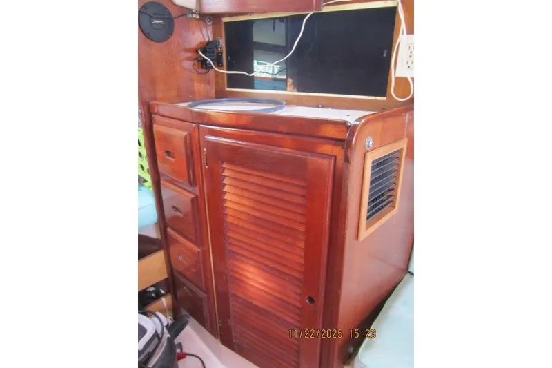 Slide: The Image of 1986 Catalina 30 MkII interior with wooden cabinetry and storage drawers. - 42