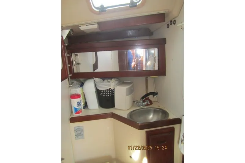 Slide: The Image of Compact bathroom in a 1986 Catalina 30 MkII sailboat with sink and storage. - 44