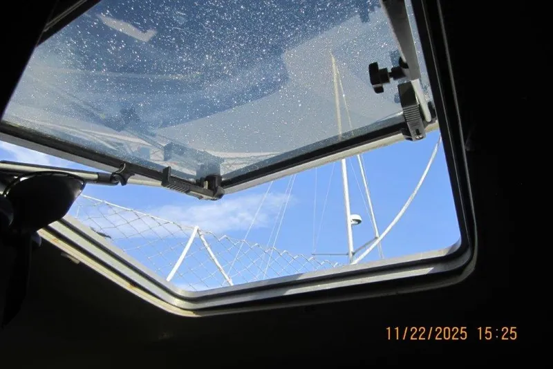 Slide: The Image of Open hatch view from 1986 Catalina 30 MkII sailboat, showing mast and blue sky. - 48