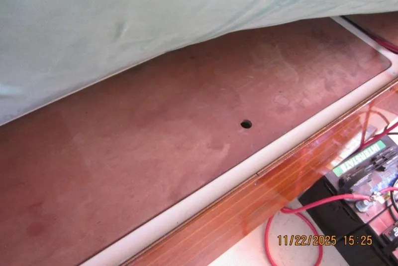 Slide: The Image of Interior of 1986 Catalina 30 MkII sailboat showing battery and wooden panel. - 50