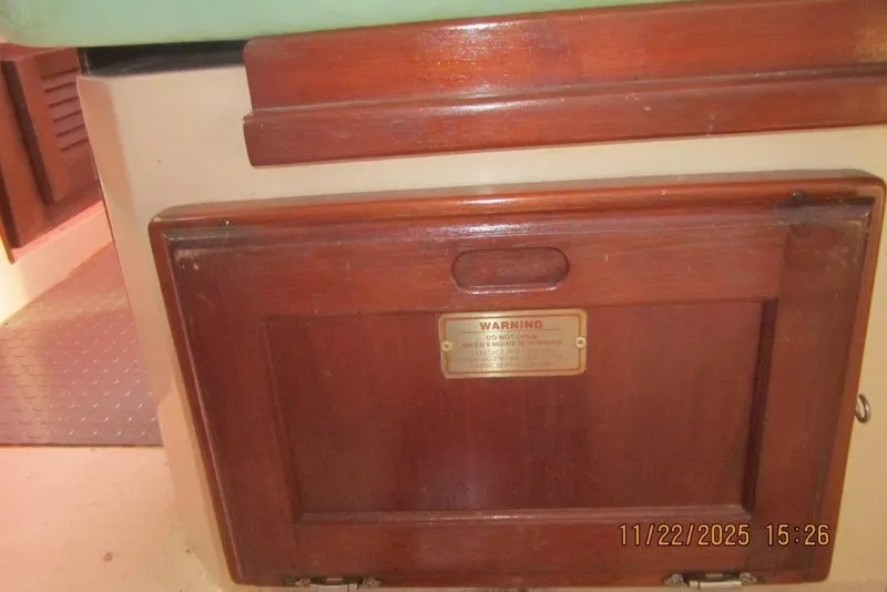 Slide: The Image of Wooden panel with warning sign inside a 1986 Catalina 30 MkII sailboat cabin. - 52