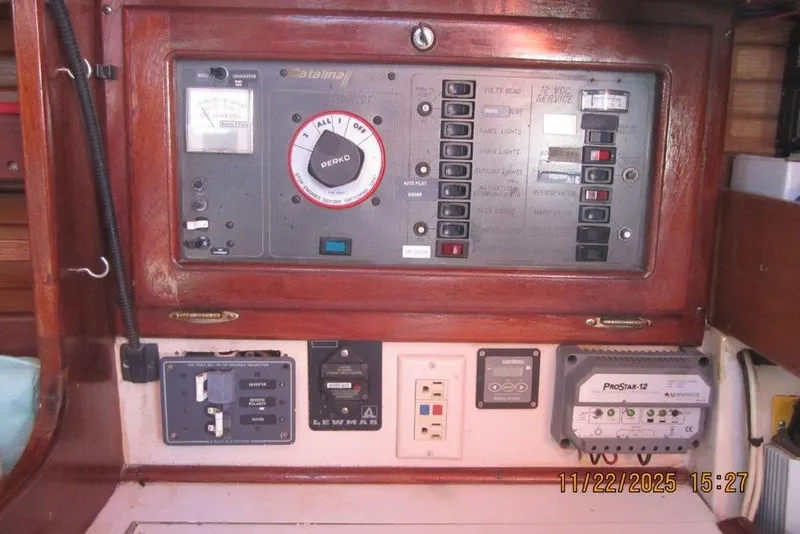 Slide: The Image of Electrical panel of a 1986 Catalina 30 MkII sailboat, featuring various switches and controls. - 58