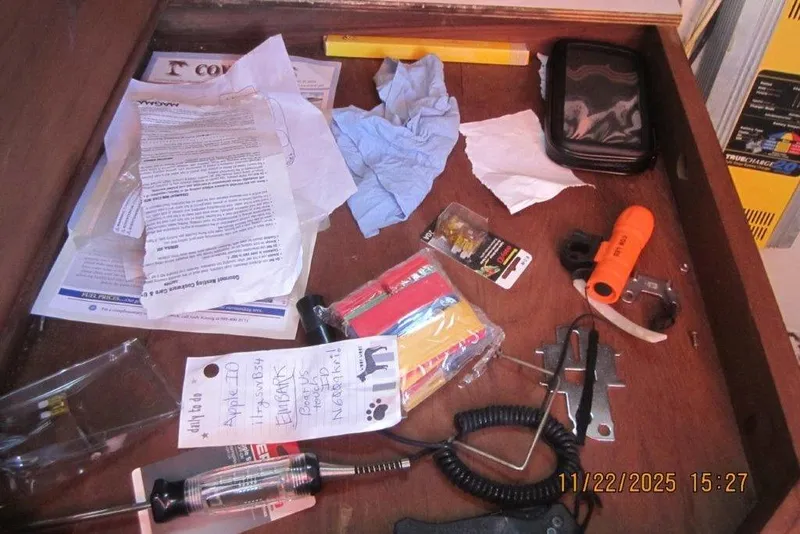 Slide: The Image of Drawer contents on a 1986 Catalina 30 MkII, including tools, papers, and miscellaneous items. - 59