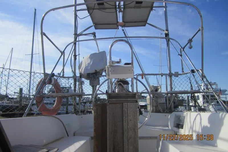 Slide: The Image of Cockpit view of a 1986 Catalina 30 MkII sailboat with marina background. - 62