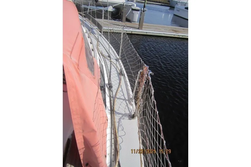 Slide: The Image of 1986 Catalina 30 MkII sailboat deck with safety netting at marina. - 63