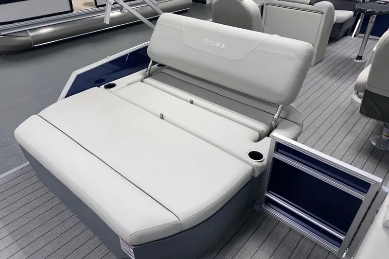 Slide: The Image of 2026 Sylvan Mirage 8522 CLZ DH boat interior with luxurious seating and cup holders. - 10