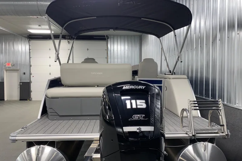 Slide: The Image of 2026 Sylvan Mirage 8522 CLZ DH pontoon boat with Mercury 115 engine in a garage. - 19