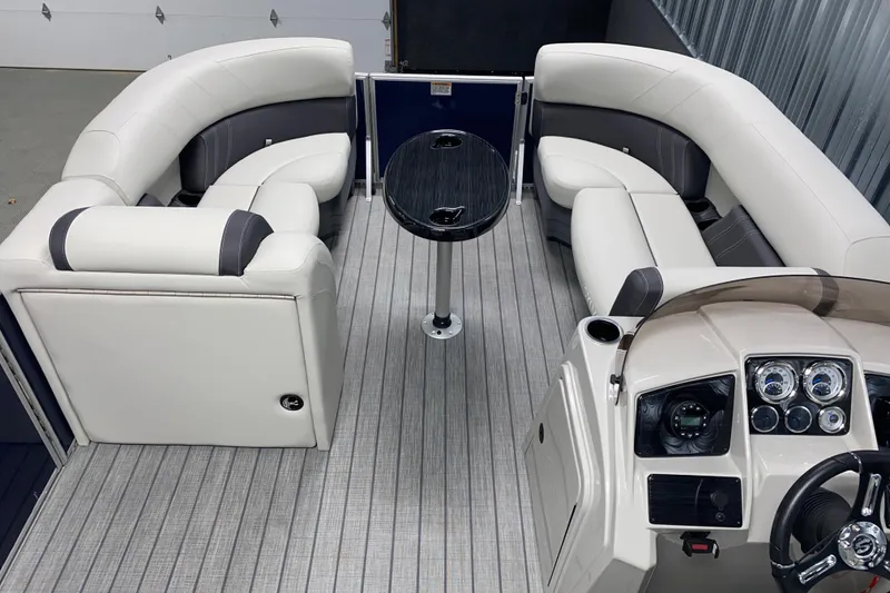 Slide: The Image of 2026 Sylvan Mirage 8522 CLZ DH pontoon boat interior with plush seating and modern dashboard. - 4