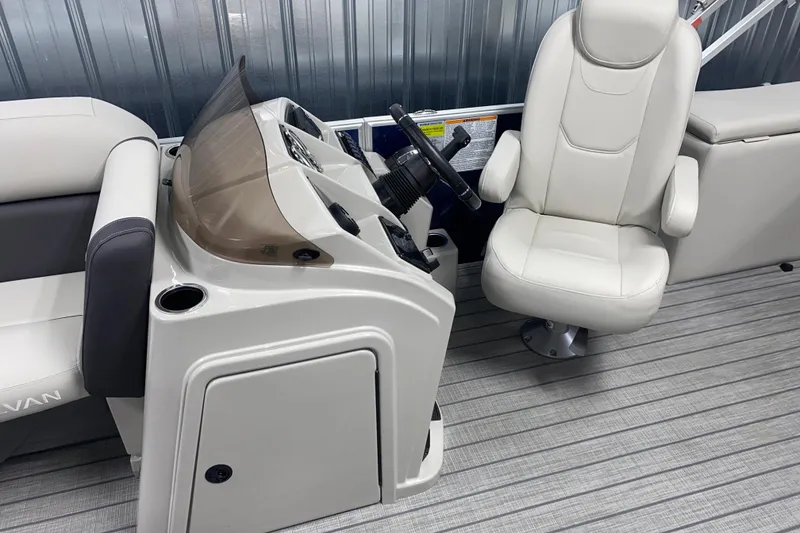 Slide: The Image of 2026 Sylvan Mirage 8522 CLZ DH boat interior with helm and captain's chair. - 6