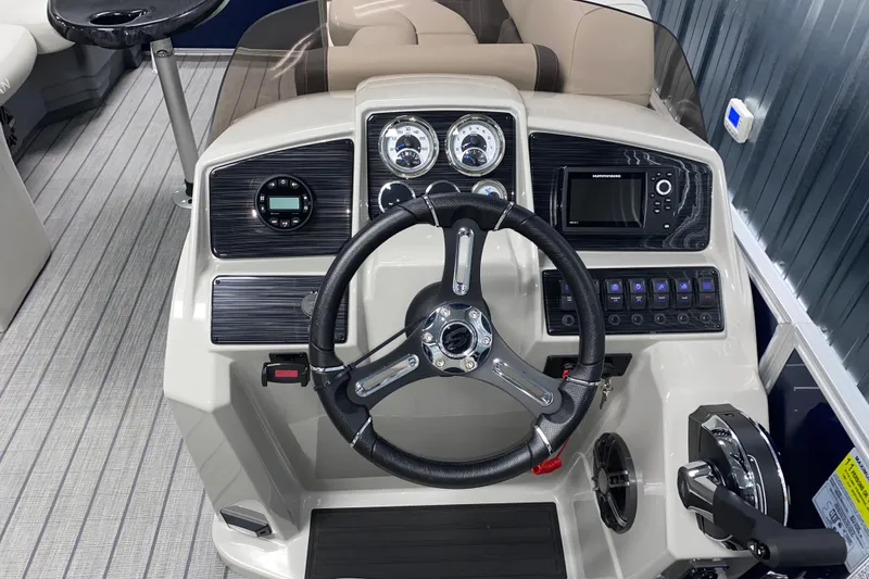 Slide: The Image of 2026 Sylvan Mirage 8522 CLZ DH boat dashboard with steering wheel and controls. - 9