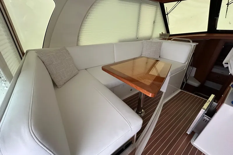Slide: The Image of Luxurious interior of 2023 Back Cove 39O yacht with elegant seating and wooden table. - 15