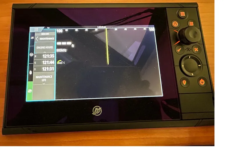 Slide: The Image of Display screen of a 2023 Back Cove 39O boat showing engine hours and maintenance data. - 29