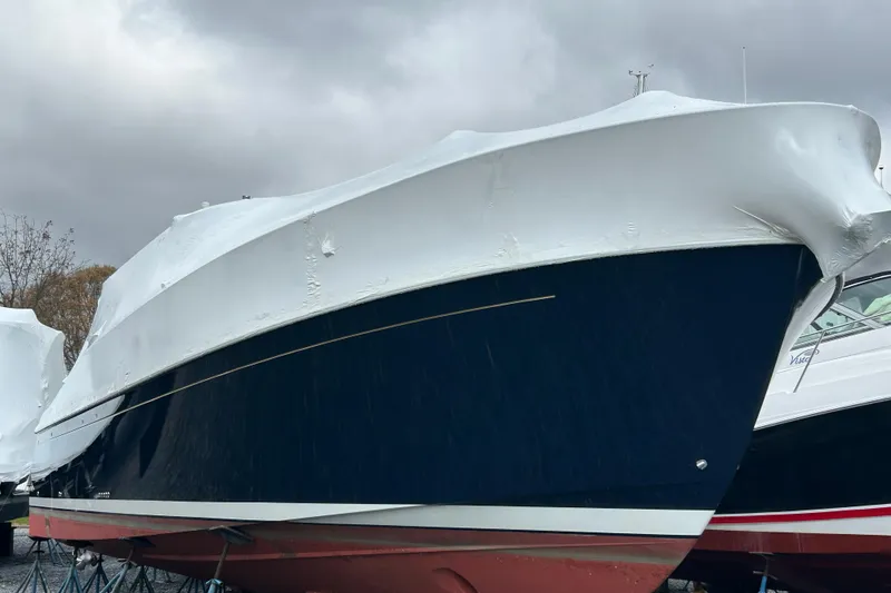 Slide: The Image of 2023 Back Cove 39O boat covered in protective wrap, easily boarded with zipper door. - 4