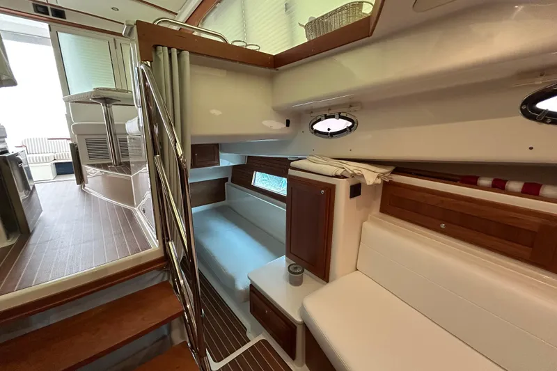 Slide: The Image of Interior of 2023 Back Cove 39O yacht, featuring cozy seating and elegant wood finishes. - 42
