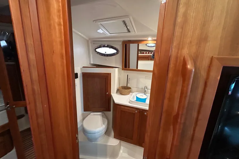 Slide: The Image of 2023 Back Cove 39O yacht bathroom with wooden cabinetry and modern fixtures. - 43
