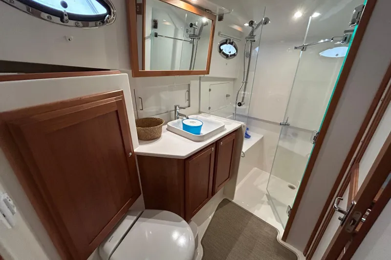 Slide: The Image of Luxurious bathroom in 2023 Back Cove 39O yacht with modern fixtures and wooden cabinetry. - 45