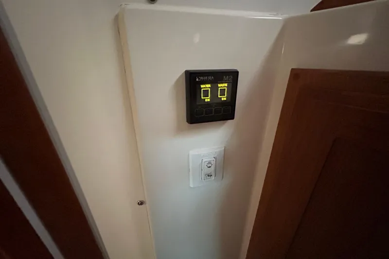 Slide: The Image of Control panel inside 2023 Back Cove 39O boat, displaying water and waste levels. - 46