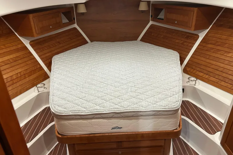Slide: The Image of 2023 Back Cove 39O cabin interior with wooden accents and a comfortable bed. - 47
