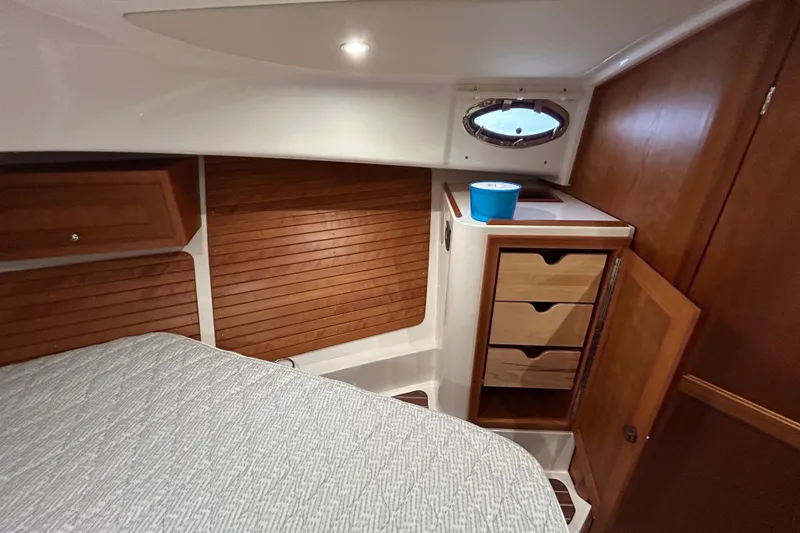 Slide: The Image of 2023 Back Cove 39O cabin interior with wood paneling and storage drawers. - 50