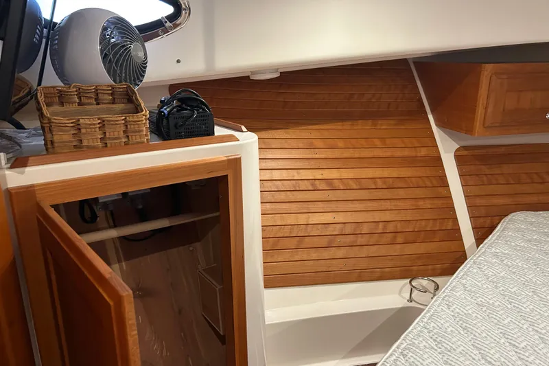 Slide: The Image of 2023 Back Cove 39O cabin interior with wooden paneling and open storage. - 51