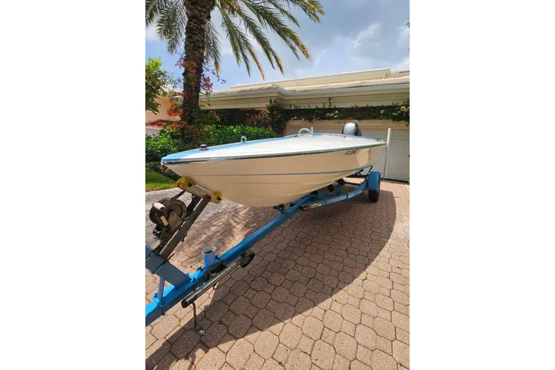 Slide: The Image of 1972 Donzi Sweet 16 Baby boat on trailer, parked in a sunny driveway. - 10