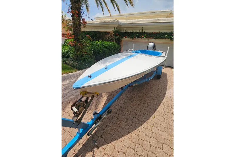 Slide: The Image of 1972 Donzi Sweet 16 Baby boat on trailer, parked in driveway with lush greenery. - 11