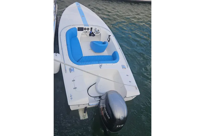 Slide: The Image of 1972 Donzi Sweet 16 Baby boat with blue interior, docked on water. - 13