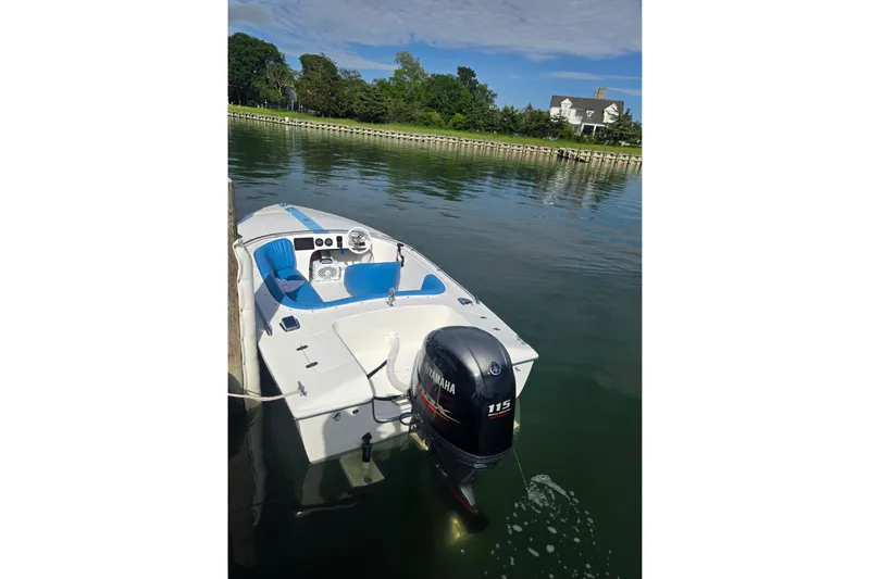 Slide: The Image of 1972 Donzi Sweet 16 Baby boat with Yamaha 115 outboard motor docked on calm water. - 14