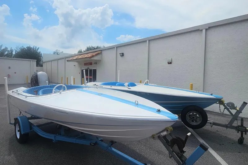 Slide: The Image of 1972 Donzi Sweet 16 Baby boats on trailers, parked outdoors under a cloudy sky. - 15