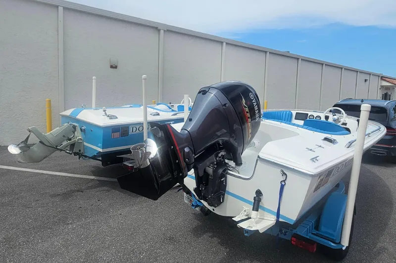 Slide: The Image of 1972 Donzi Sweet 16 Baby boat with Yamaha outboard motor in a parking lot. - 16