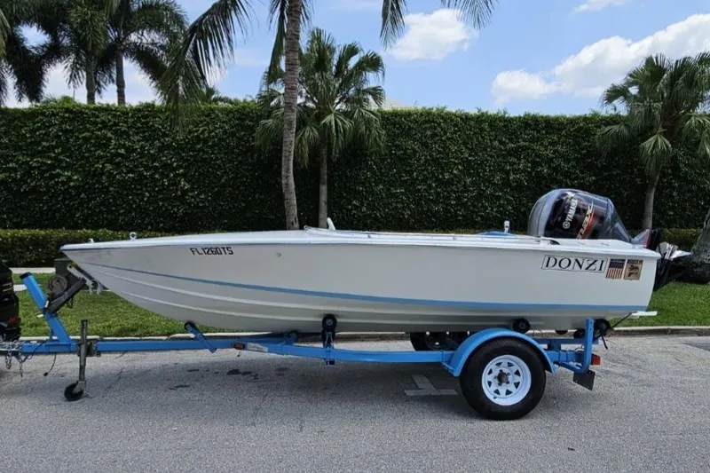 Slide: The Image of 1972 Donzi Sweet 16 Baby boat on trailer, parked near palm trees. - 3