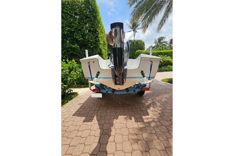 Slide: The Image of 1972 Donzi Sweet 16 Baby boat on trailer, surrounded by lush greenery. - 9