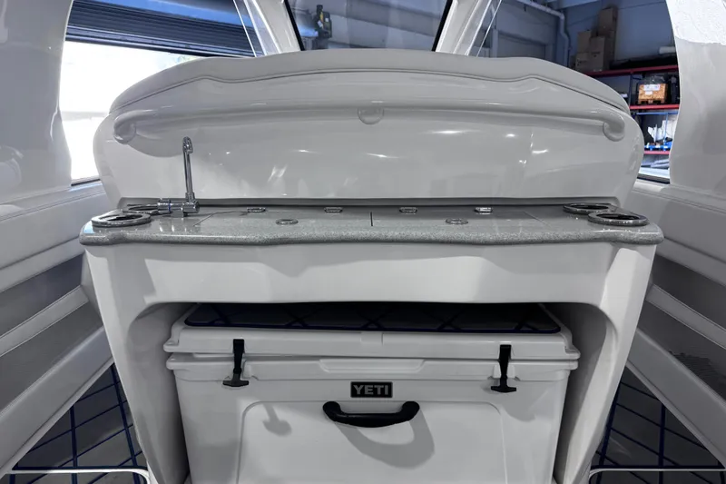 Slide: The Image of 2024 Deep Impact 399 Sport boat interior with JL Audio speakers and quilted upholstery. - 12