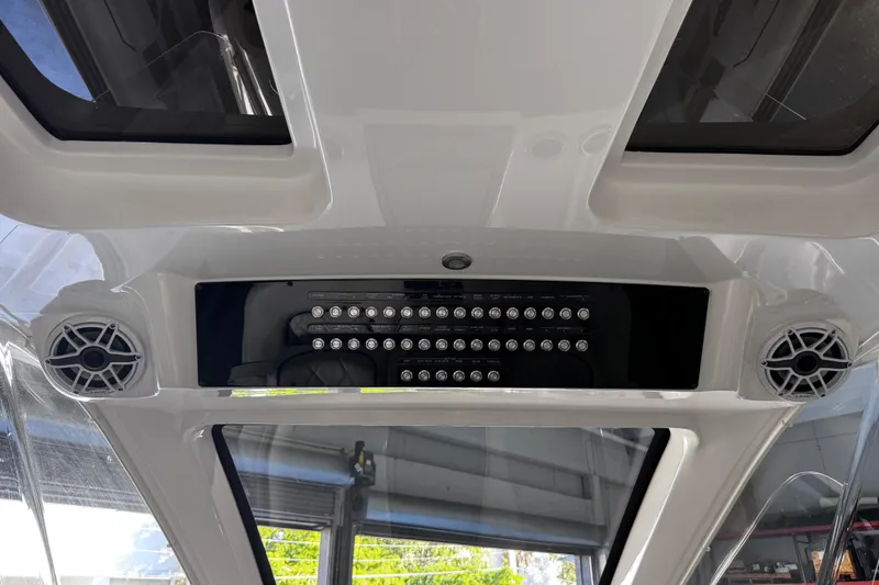 Slide: The Image of 2024 Deep Impact 399 Sport boat interior with white seating and blue accents. - 19