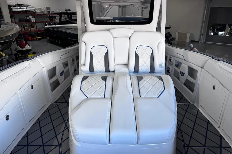 Slide: The Image of 2024 Deep Impact 399 Sport boat interior with speakers and storage compartment. - 25