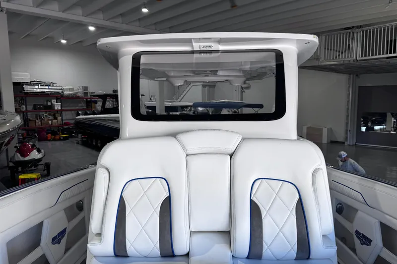 Slide: The Image of 2024 Deep Impact 399 Sport boat interior with Yeti cooler and sleek countertop design. - 26