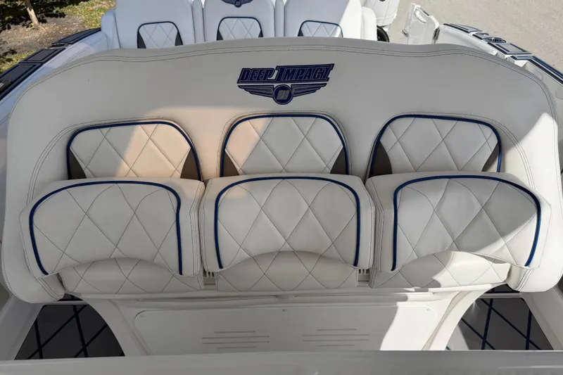 Slide: The Image of 2024 Deep Impact 399 Sport boat seats with white and blue diamond stitching. - 29