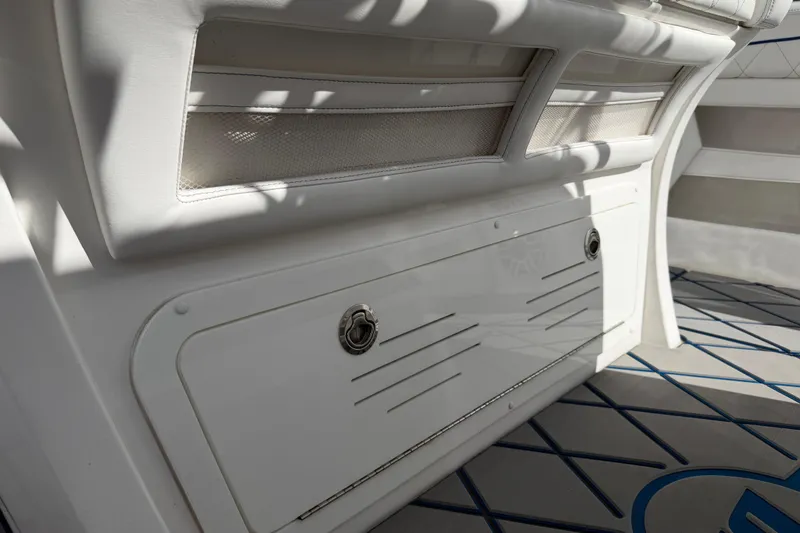 Slide: The Image of 2024 Deep Impact 399 Sport boat interior with white seating and storage compartment. - 32