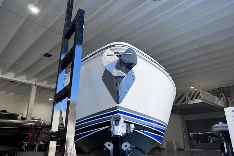 Slide: The Image of 2024 Deep Impact 399 Sport boat with blue and white design on a trailer. - 6