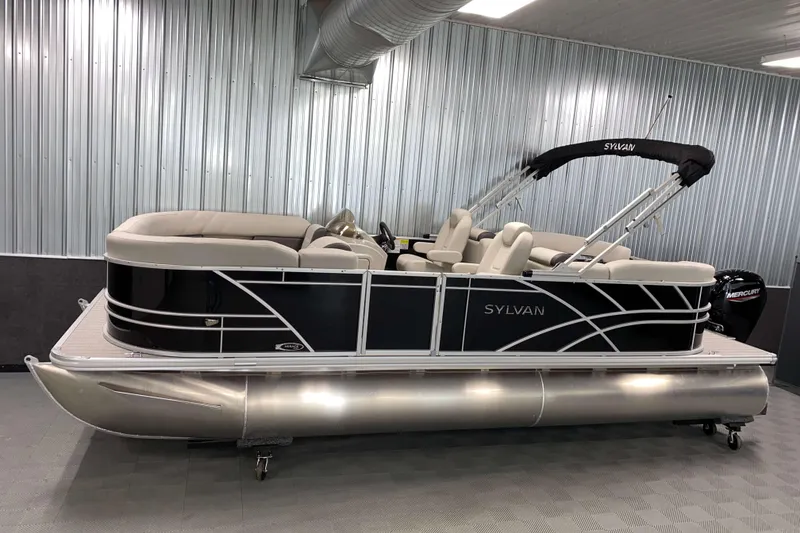 The Image of 2026 Sylvan Mirage 8522 LZ pontoon boat in a modern indoor showroom. - 0