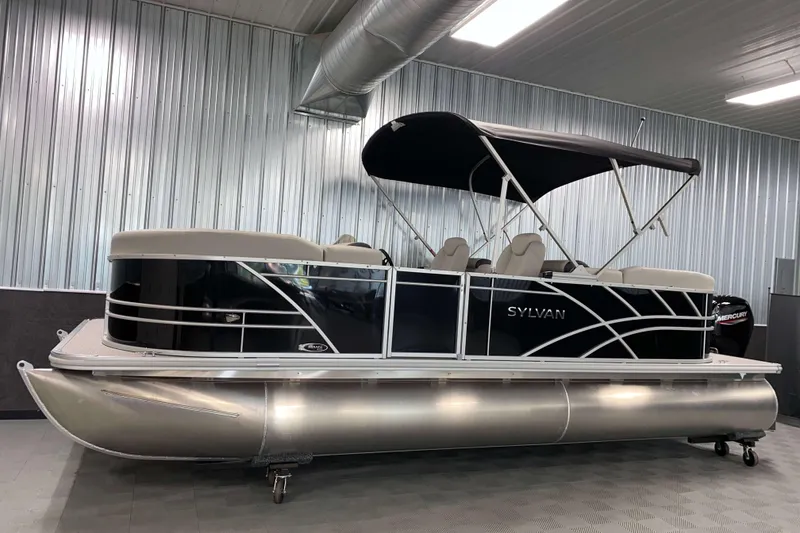Slide: The Image of 2026 Sylvan Mirage 8522 LZ pontoon boat in a showroom with metallic siding. - 11