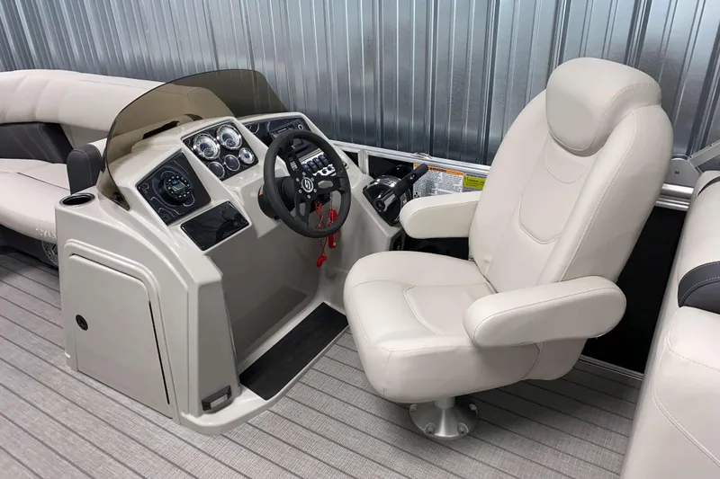 Slide: The Image of 2026 Sylvan Mirage 8522 LZ boat interior with captain's chair and control panel. - 6